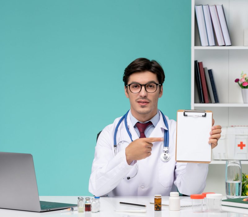 medical-smart-young-doctor-lab-coat-working-remotely-computer-holding-notes